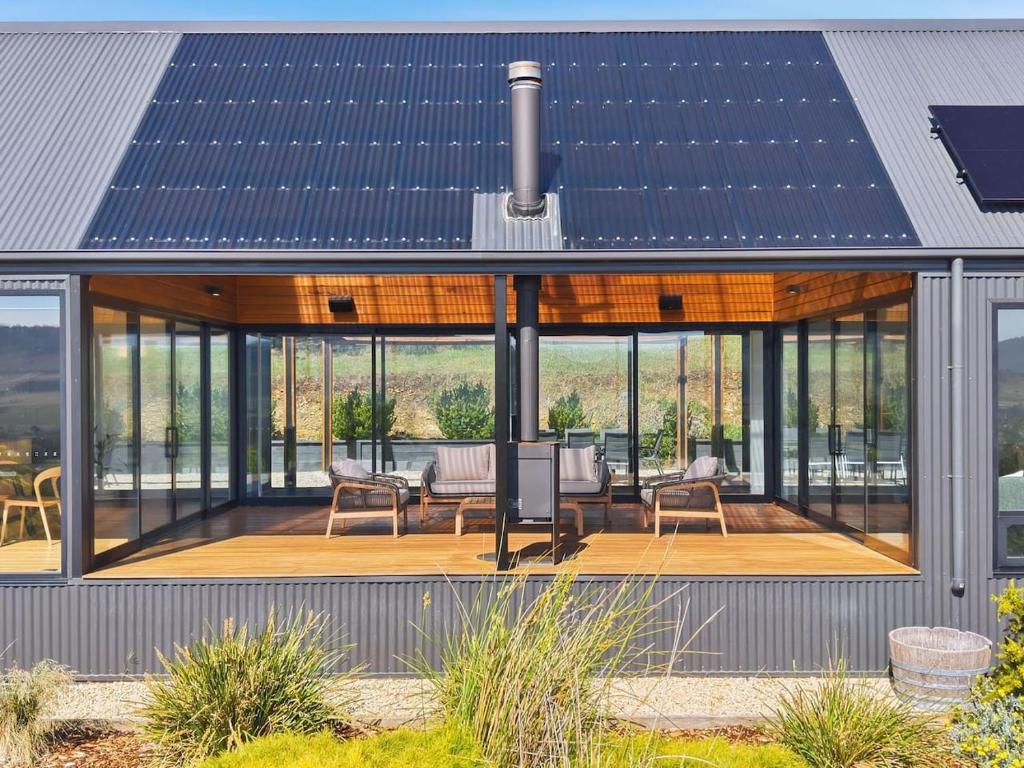 a house with a solar roof on top of it at Richmond Valley Luxe Escape in Richmond