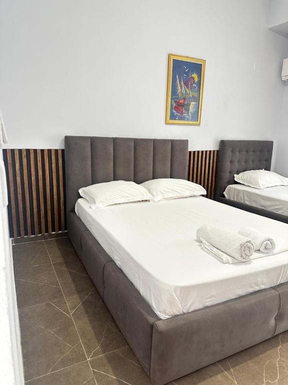 a bedroom with a large bed with white sheets at Almer room 2 in Himare