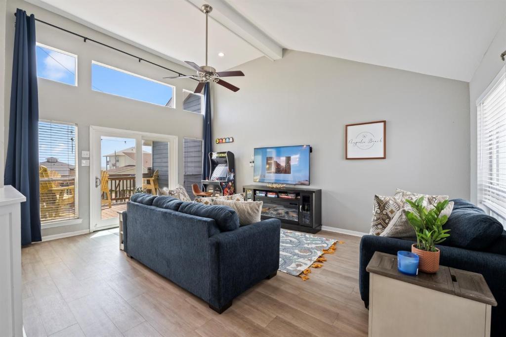 a living room with two couches and a tv at Gulf-View Townhome Hot Tub 2-Min Beach Walk in Galveston
