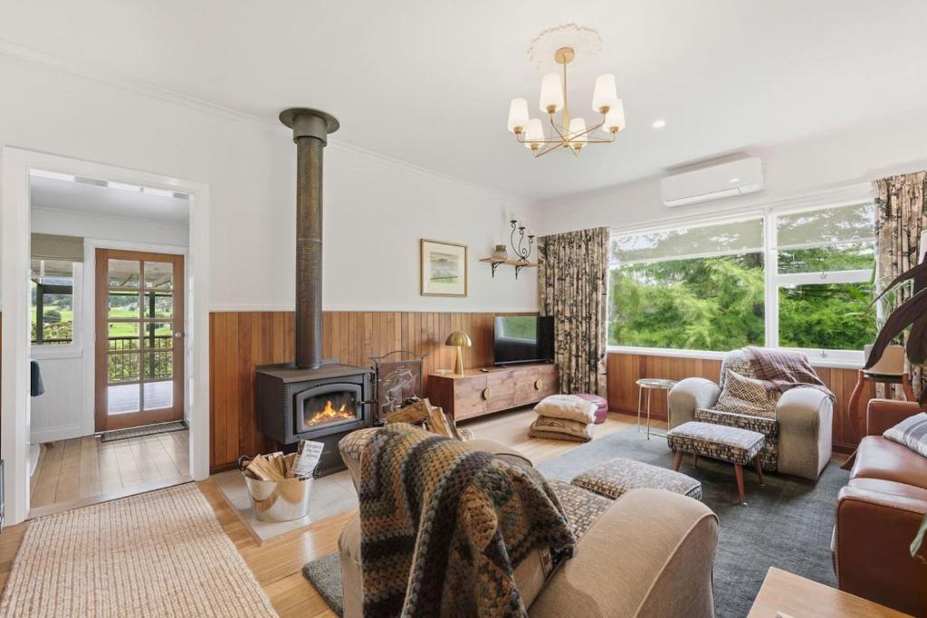a living room with a wood burning stove in it at Riverbend Escape, Judbury in Judbury