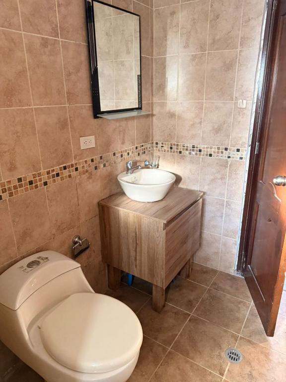 a bathroom with a toilet and a sink at Quinta San Agustin in Latacunga
