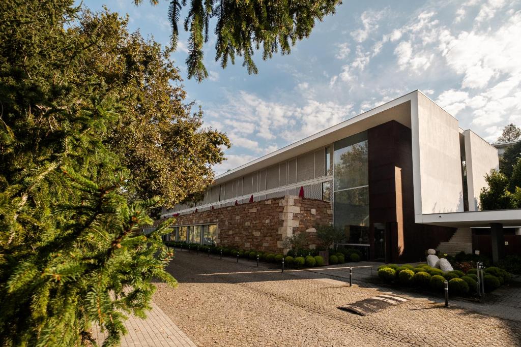 a building with a christmas tree in front of it at Axis Ponte de Lima Golf Resort Hotel in Ponte de Lima