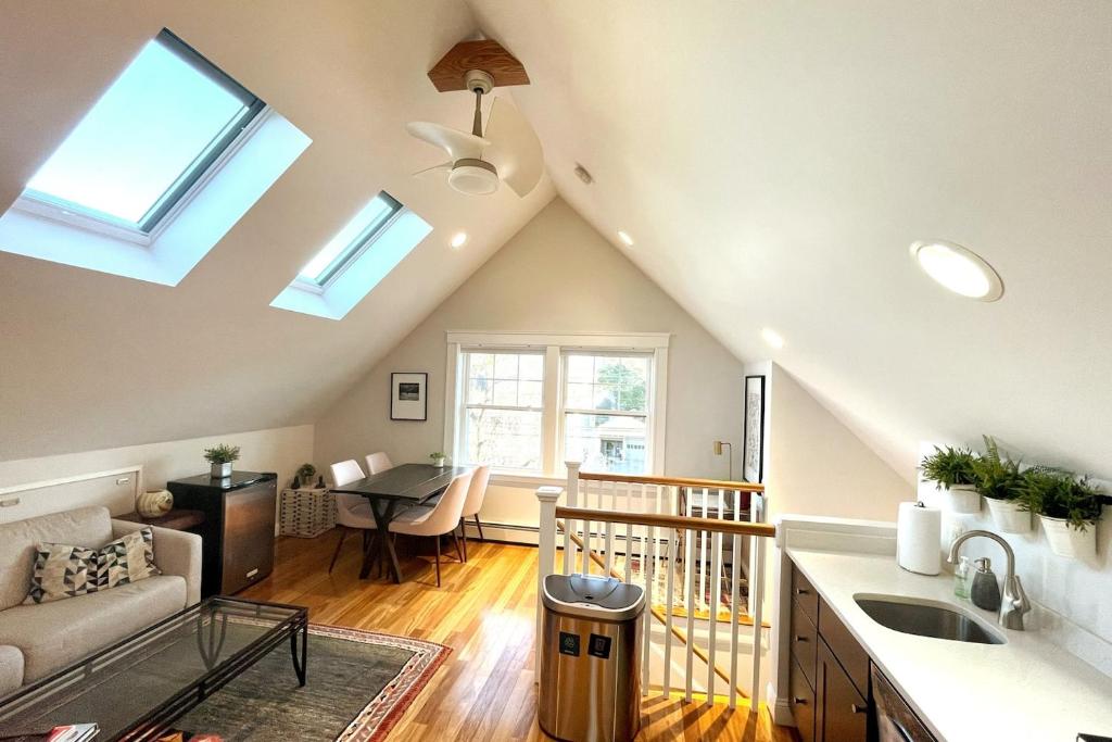 a kitchen and living room with a vaulted ceiling at 2BR Suite - Bright - Modern - Central AC - Parking in Arlington