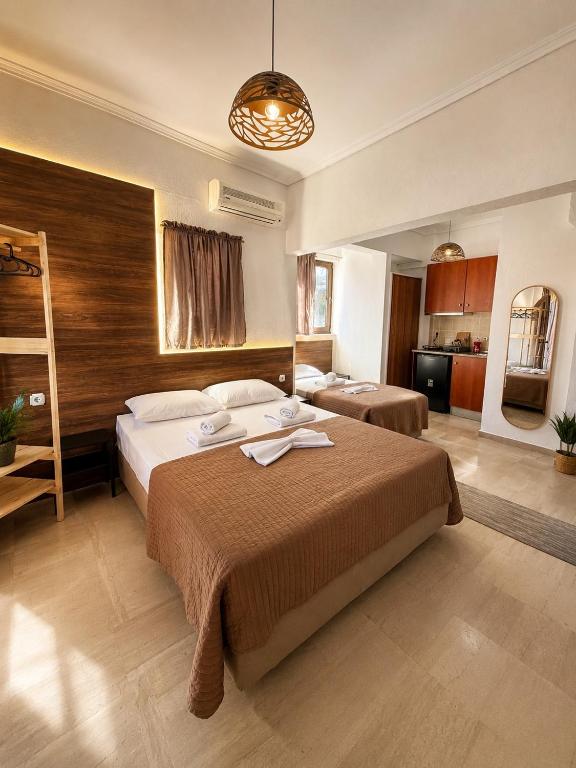 a bedroom with a large bed and a kitchen at Kiki by the sea Villa in Paralia Katerinis