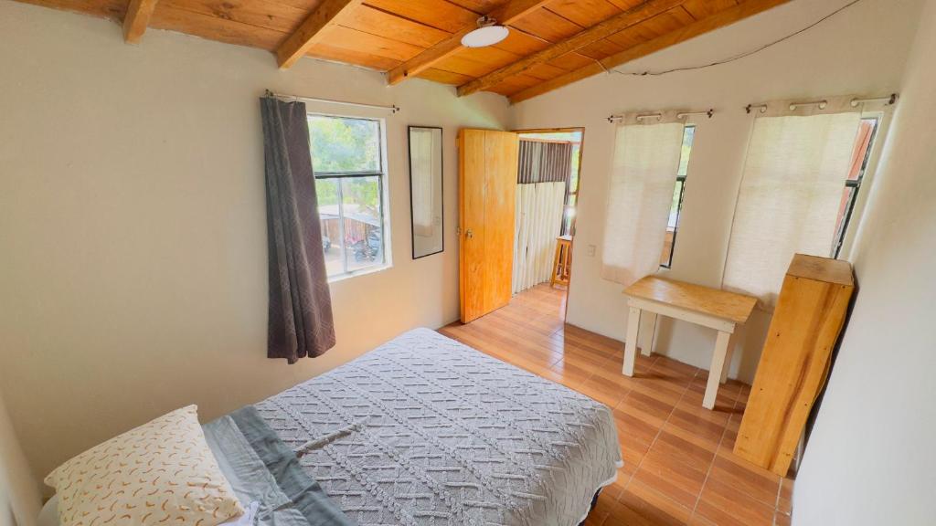 a bedroom with a bed and a window at Luminous Haven Atitlan #1 in San Marcos La Laguna