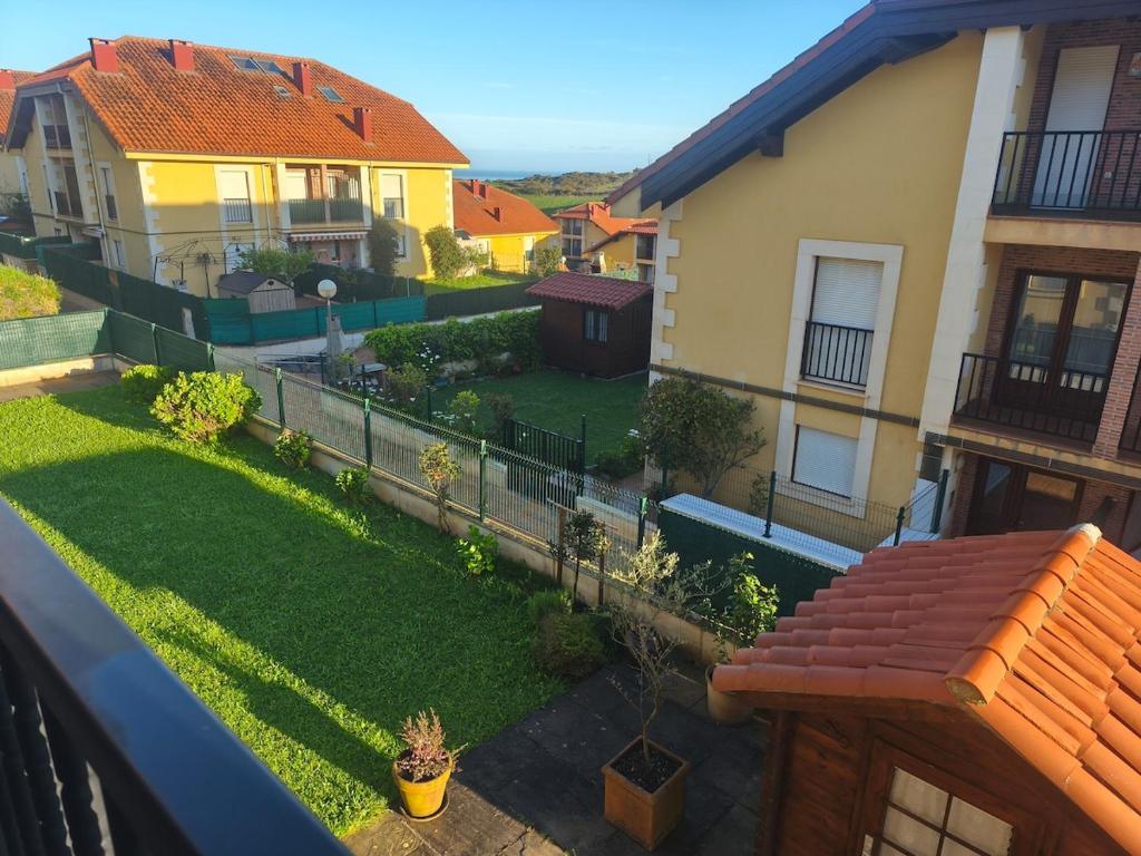 a view from a balcony of a yard with houses at Casa Tia Nieves in Ruiloba