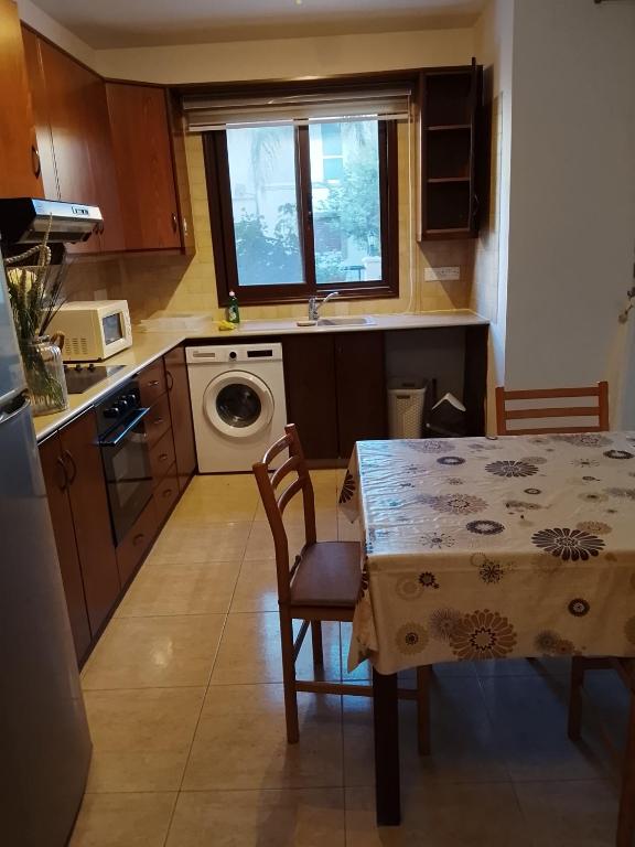 a kitchen with a table and a sink and a table and chairs at Millennium falcon in Larnaca
