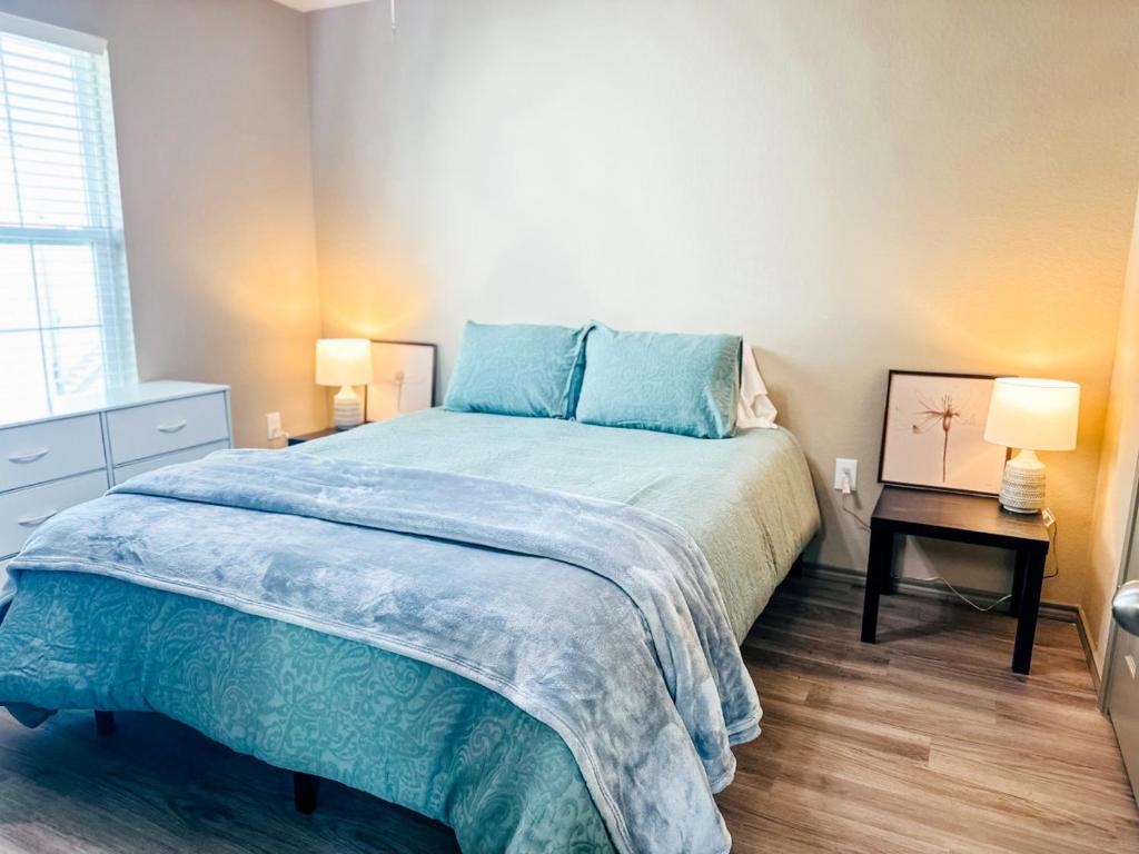 a bedroom with a large bed with blue pillows at Cozy Comfort 1BR - Renovated, Private, Pet Welcome in Texas City