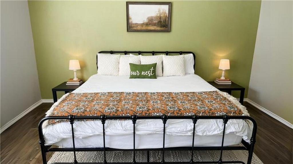 a bedroom with a bed with two lamps on either side at Pool View Escape - Near Shops and Dining in Corpus Christi