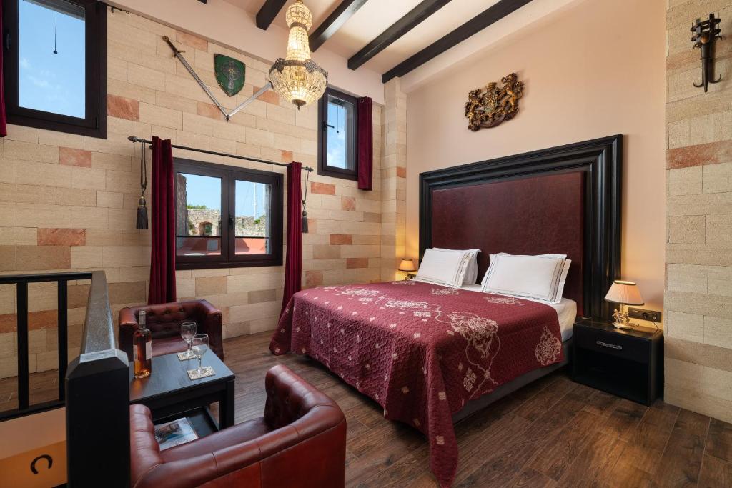 a bedroom with a bed and a couch and a chair at Grand Master Suite in Rhodes Town