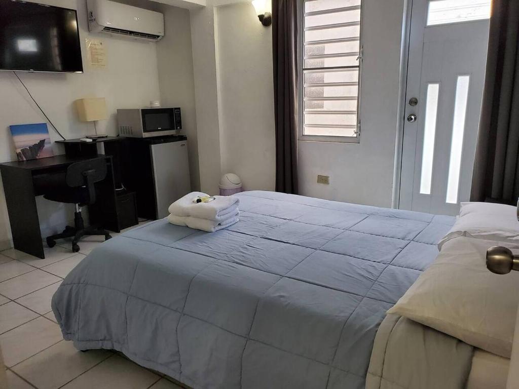 a bedroom with a bed with a towel on it at Above The Plaza 4 (6 guest) in Rincon