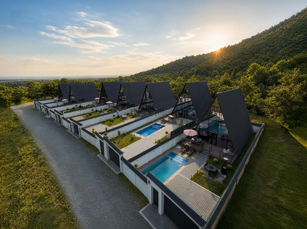 an aerial view of a building with a pool and a resort at Qafqaz Falcon Chalet in Gabala