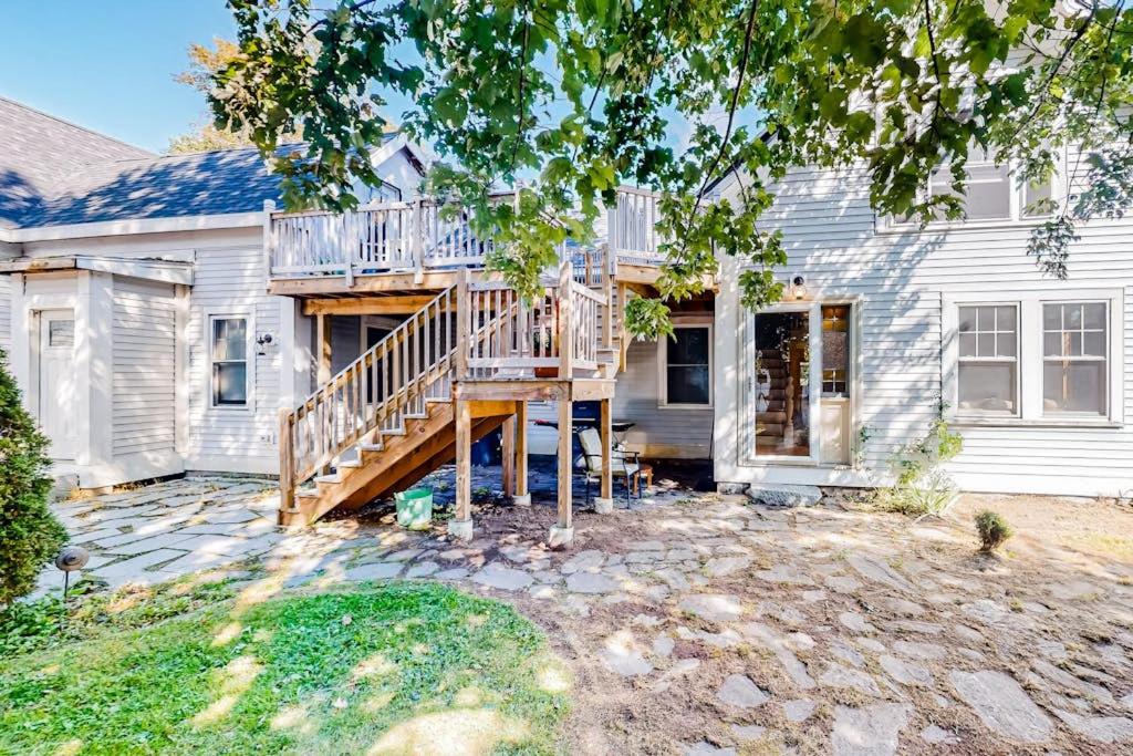 a house with a deck on the side of it at 2-story apartment steps from the harbor & downtown in Boothbay Harbor