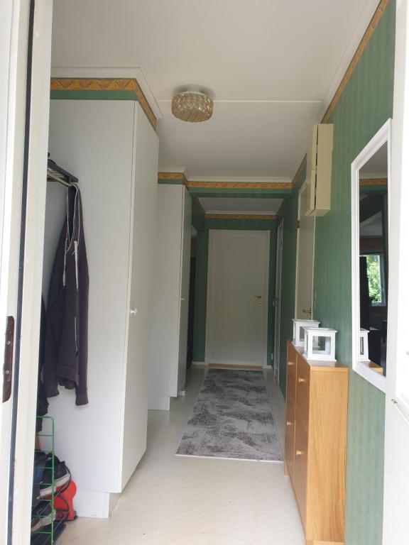 a hallway leading into a room with a microwave at Lägenhet in Köpingsvik
