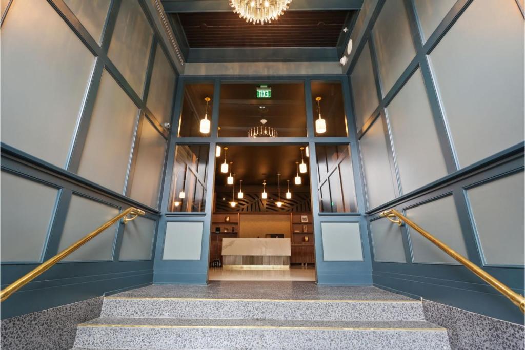 a stairway leading to a room with a bed at Eleven48 Hotel in New Orleans