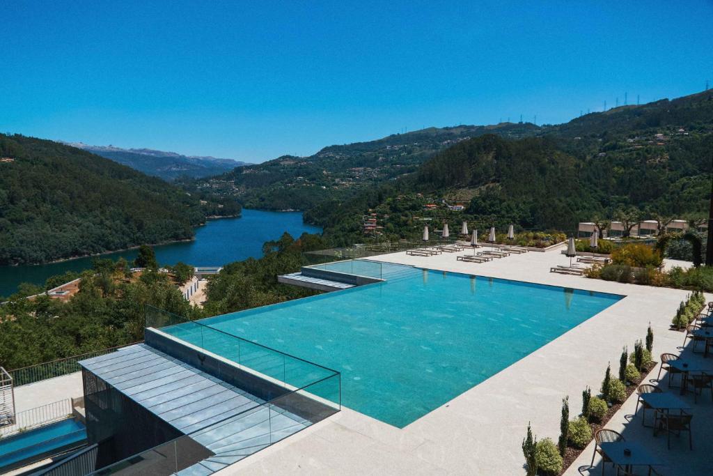 an image of a swimming pool with a view of a river at Hotel Aquafalls in Caniçada