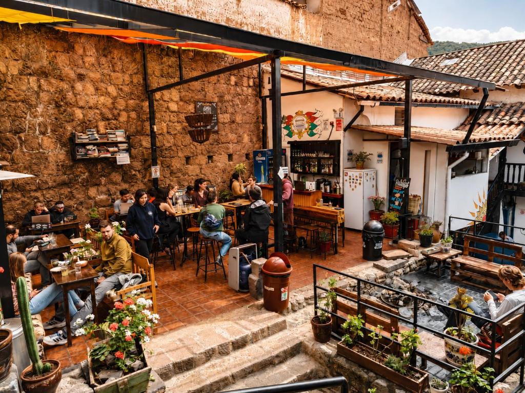 a group of people sitting at tables in a restaurant at Intro Hostels Cusco in Cusco