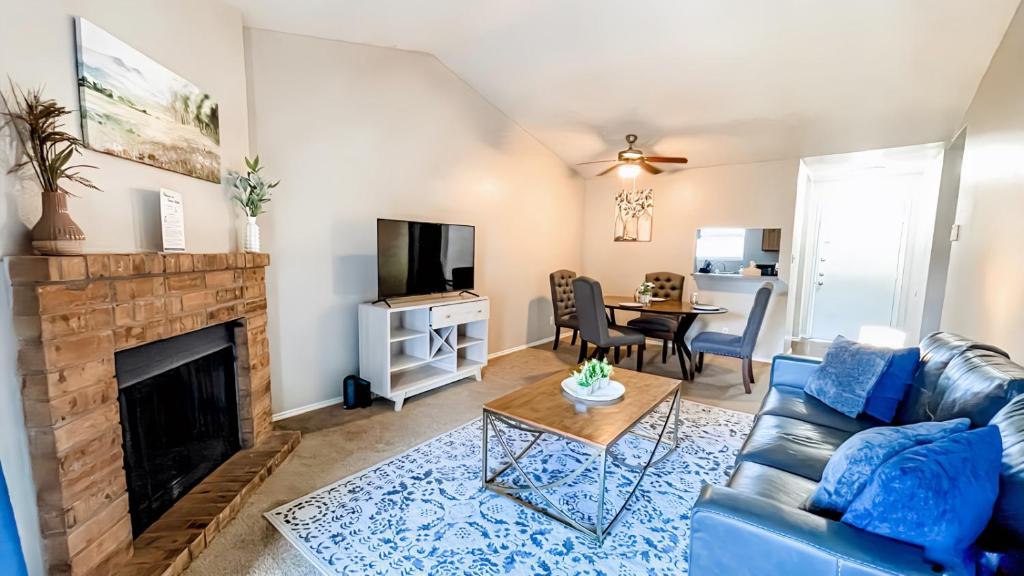 a living room with a blue couch and a fireplace at 10 Min to Downtown - Pet-friendly, TV with Parking in Robstown