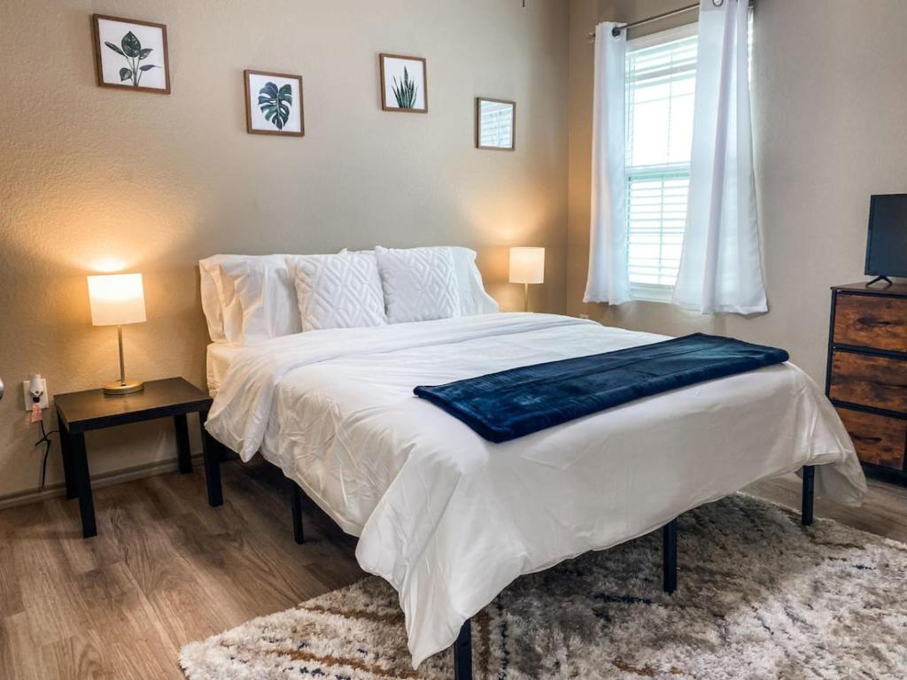 a bedroom with a large white bed and a window at Charming 1BR Getaway - Private, Pet Friendly, TV in Texas City