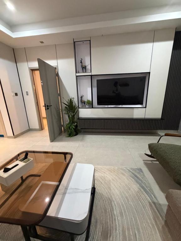 a living room with a large flat screen tv at Serene Keys Homes in Otinshi