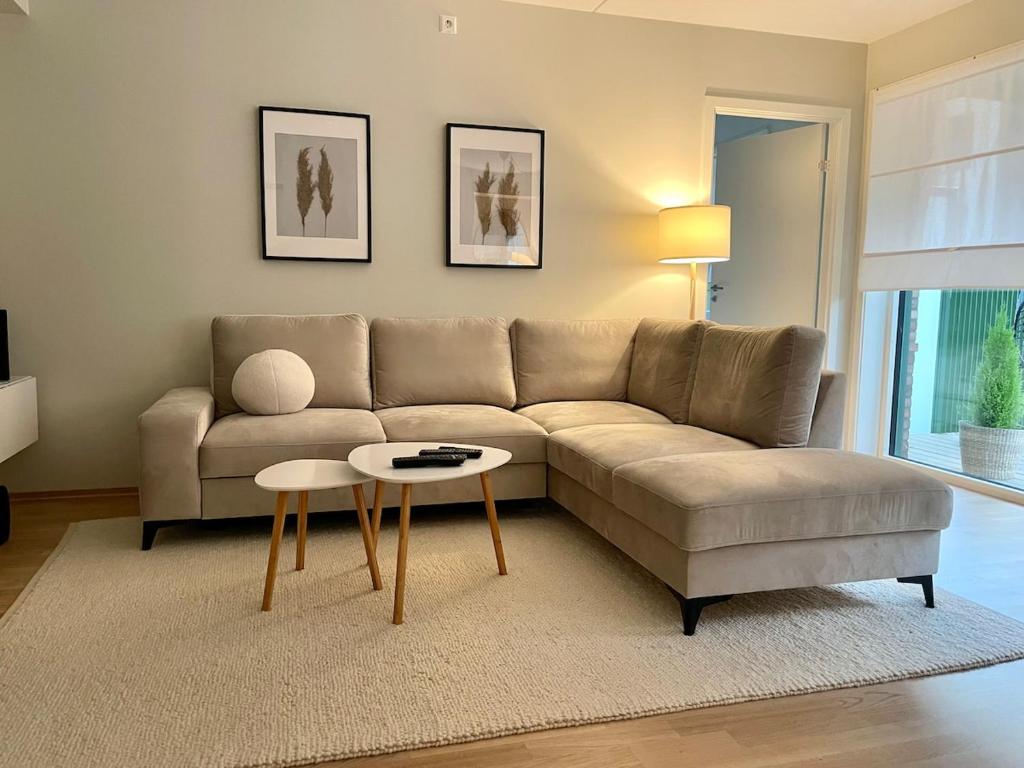 a living room with a couch and a table at Modern apartment with a private garage in Lørenskog Oslo in Lorenskog