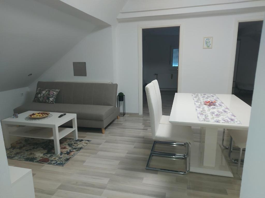 a living room with a couch and a table at Apartman Kovačić in Kutina