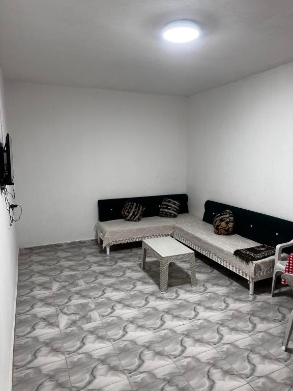 a living room with two couches and a table at Zarzis 1 in Zarzis