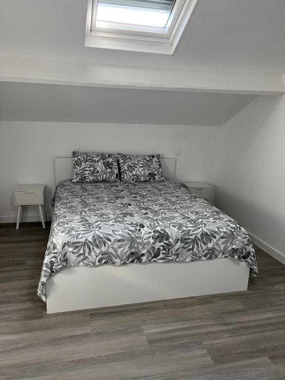 a bed in a white room with a window at Maison Teiss in Aigues-Mortes