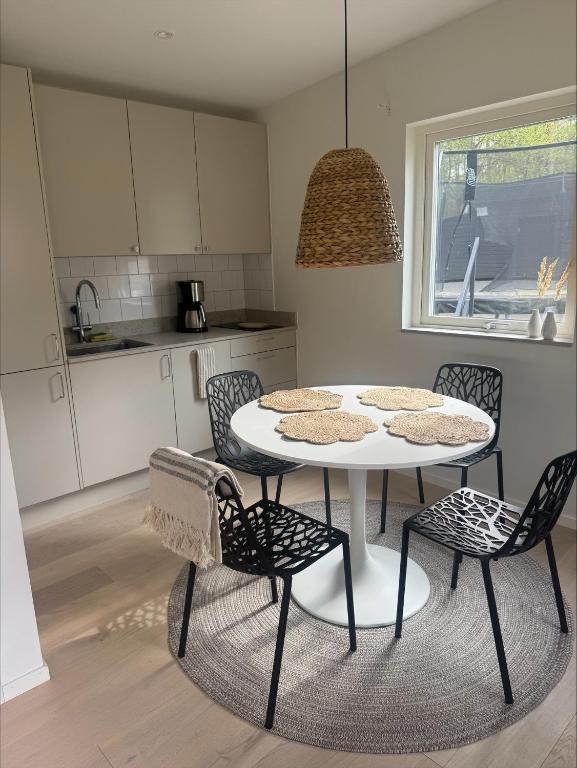 a kitchen with a table and chairs in a kitchen at Höllviksstugan in Höllviken
