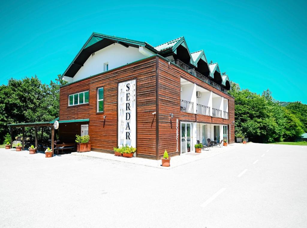 a building with a sign on the side of it at Hotel Serdar in Mojkovac