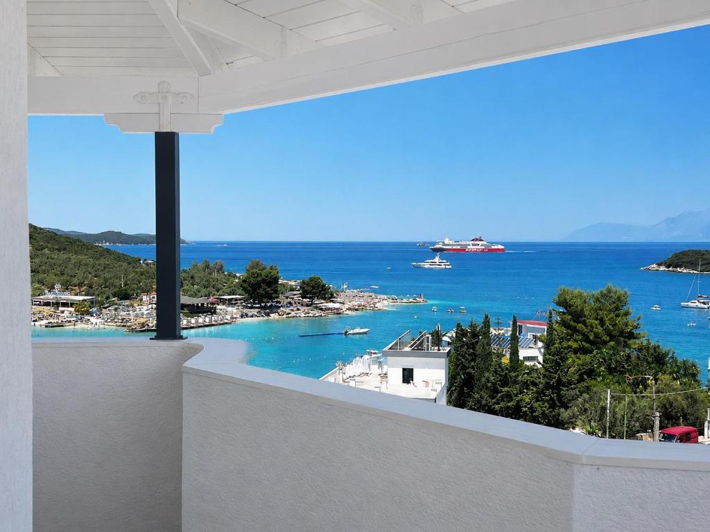 a view of the ocean from the balcony of a house at Dine Hotel in Ksamil