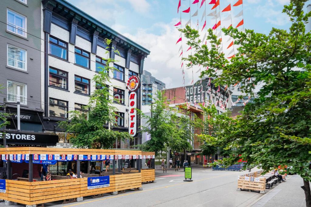 a street in a city with buildings and flags at Samesun Vancouver in Vancouver
