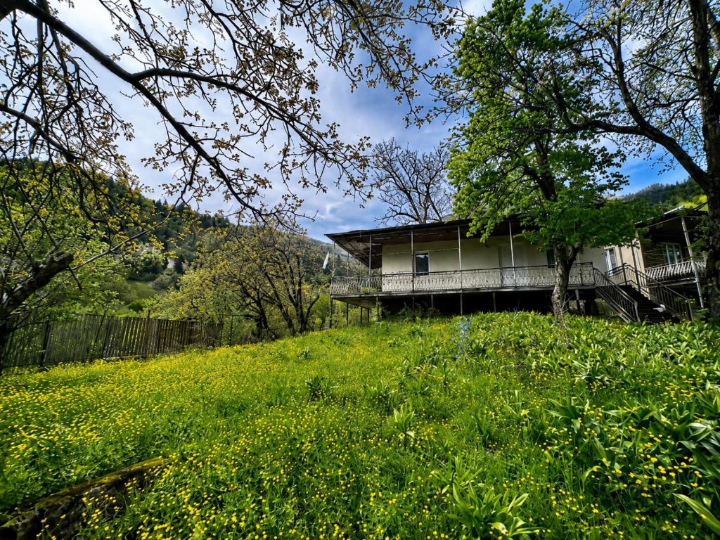 a house on a hill with a field of grass at Utsera Veranda in Utsera