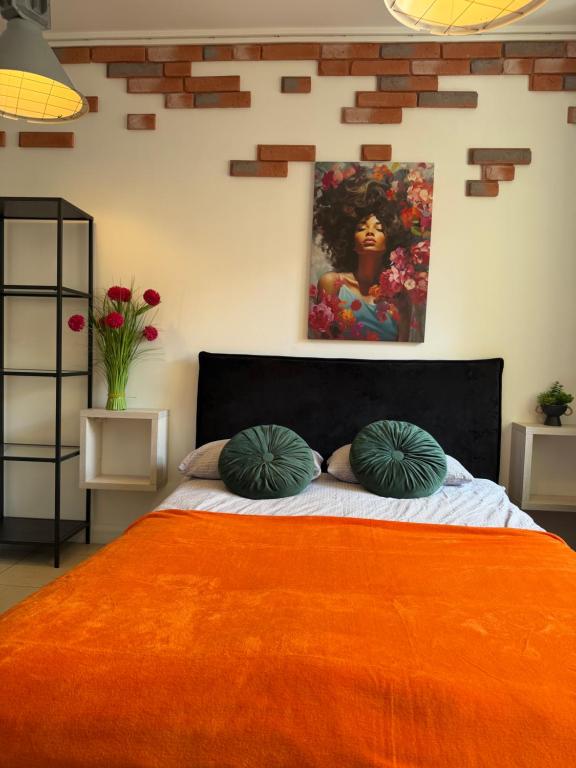 a bedroom with a bed with two pillows on it at -Mała in Kielce