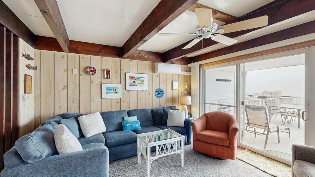 a living room with a blue couch and a chair at White Sands Village 27 in Ocean City
