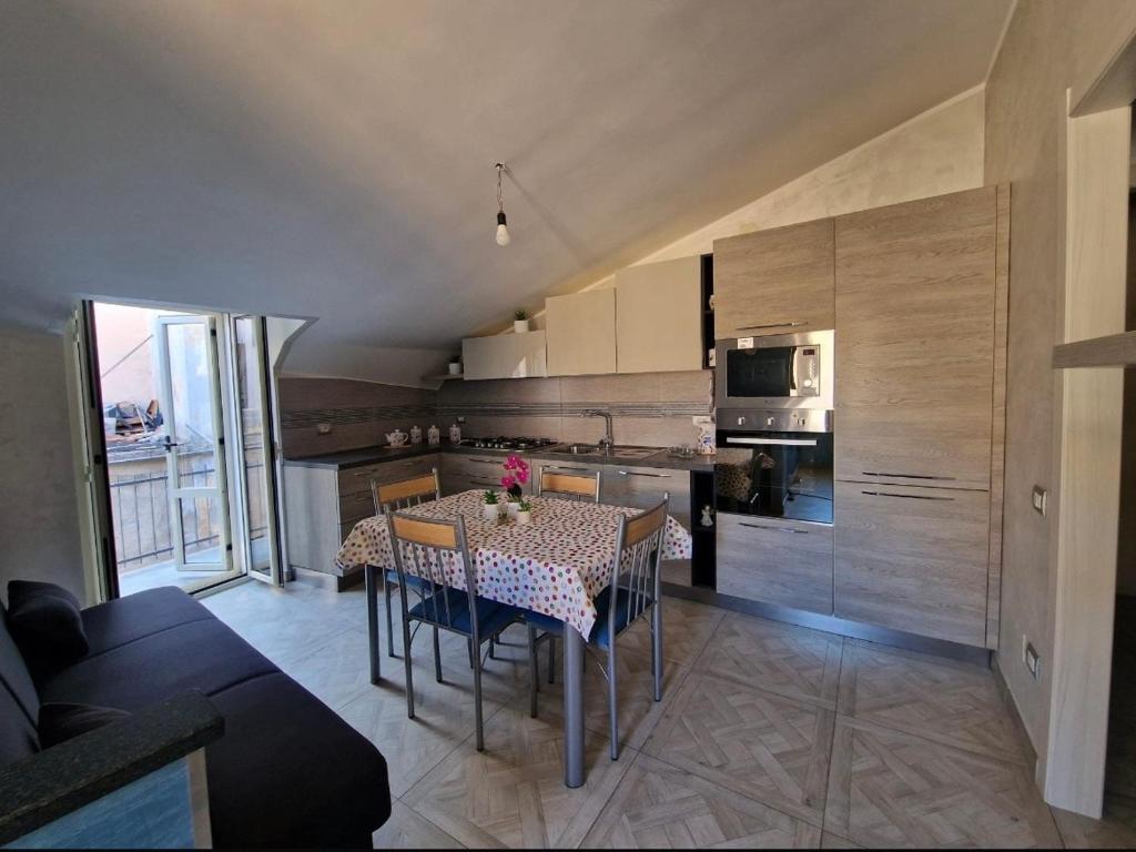 a kitchen with a table and chairs and a kitchen with a kitchen at Domus Enricucciu in Lanusei