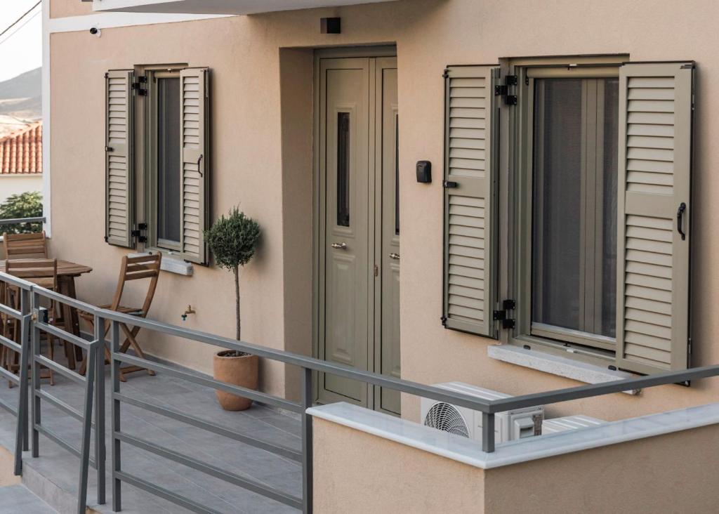 a balcony with shutters on a house at Akrolithos apartments ground floor in Platy