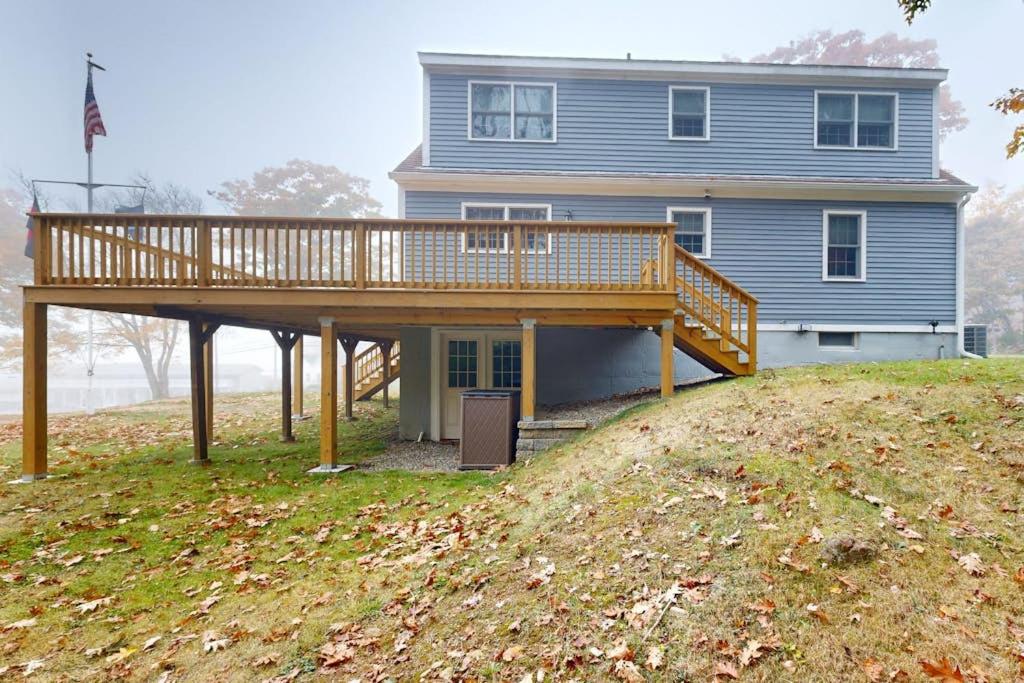 a house with a wooden deck on top of a hill at Boothbay Harbor Home with Water Views | Near Dining & Whale Watching in Boothbay Harbor