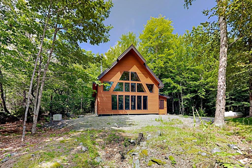 a small house in the middle of the woods at 2 beautifully designed, off-the-grid homes with amazing lakefront views & access in Franklin