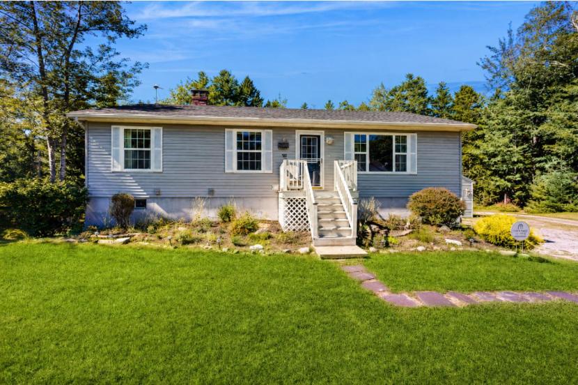 a house with a lawn in front of it at Charming cottage near the beach with balcony, deck, grill, fireplace - dogs OK in Georgetown