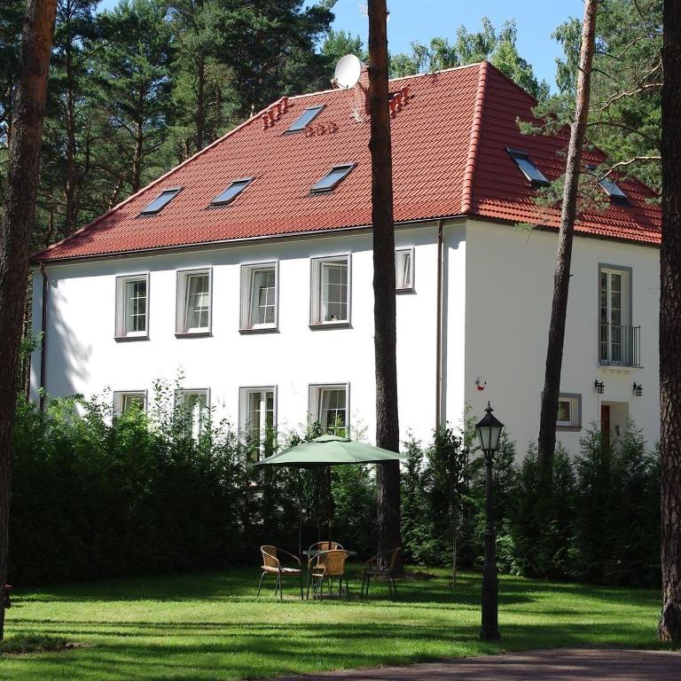 a large white house with a red roof at CasaBlanca Biały Dom in Borne Sulinowo