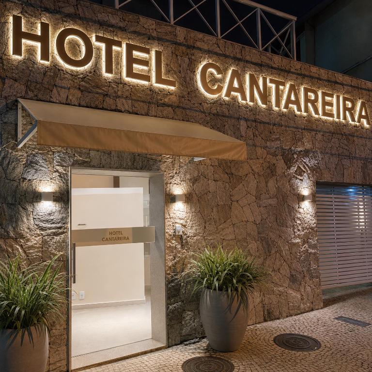 a hotel entrance with a sign above a door at Hotel Cantareira in Niterói