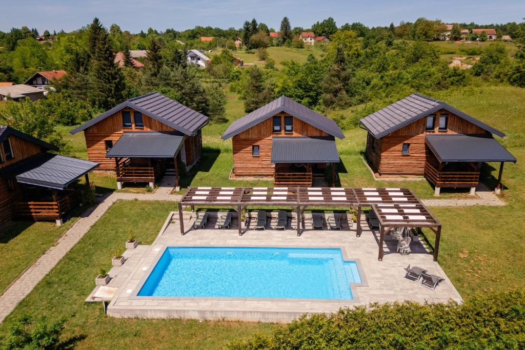 an aerial view of a resort with a pool and a cabin at Timber Fairies in Slunj