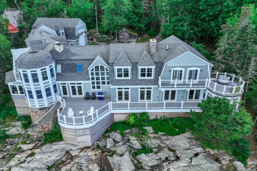 an aerial view of a large house on a cliff at Spectacular oceanfront retreat with amazing views, sunroom & washer/dryer in Georgetown