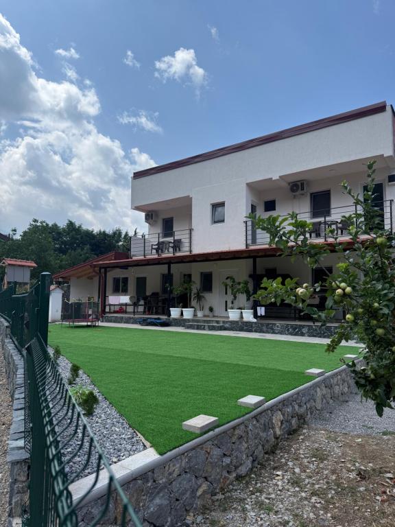 a building with a artificial lawn in front of it at The Brothers Villa in Ohrid