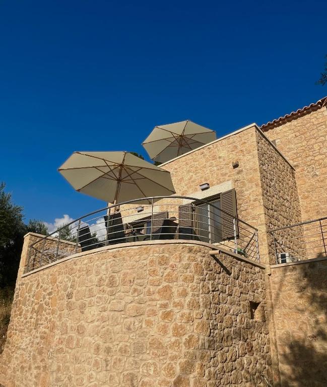 a balcony with umbrellas on top of a building at Bella Villa in Proástion