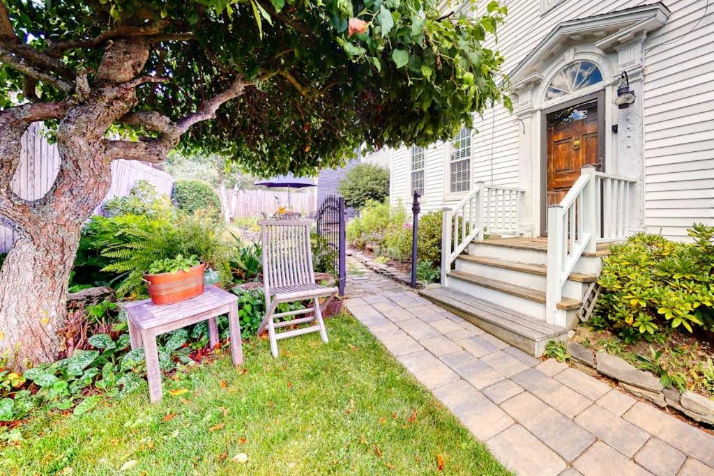 a house with a table and a chair in the yard at Lovely studio w/full kitchen/free WiFi- next to river/antique shops/restaurants in Wiscasset