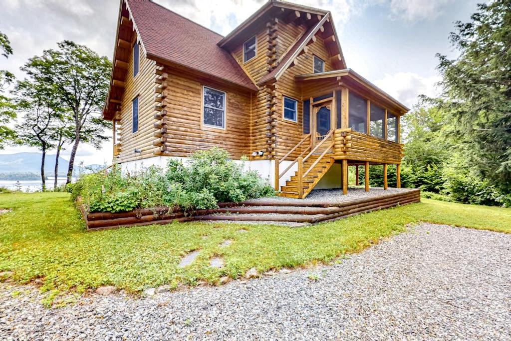 a log home with a staircase leading up to it at Tranquil Haven | Secluded waterfront house with sauna, dock, kayaks, canoe, gym in Greenville