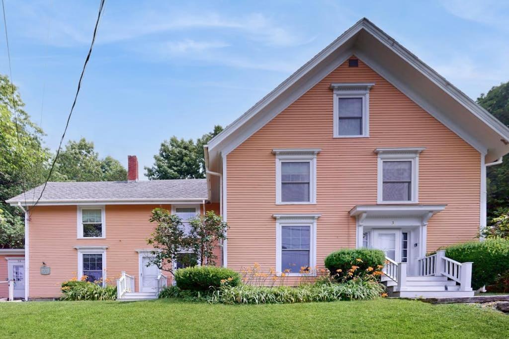 a house with a pink house at Cozy apartment with harbor view - full kitchen & washer/dryer - walk to water in Rockport