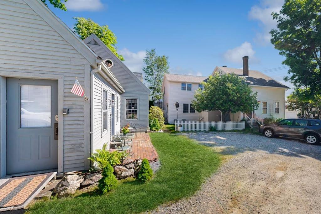 a house with a flag on the side of it at Downtown, ground floor studio near the ocean w/patio, outdoor dining area & more in Wiscasset